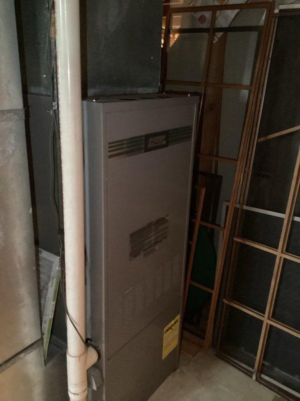 Diagnosed no-heat condition on 35-year-old furnace; found corroded and broken pressure switch hose connected to inducer motor preventing proper furnace startup. Upon full inspection, discovered cracked and severely rusted secondary heat exchanger requiring complete system replacement. Tagged unit as unsafe for operation pending replacement; service advisor scheduled for quote.