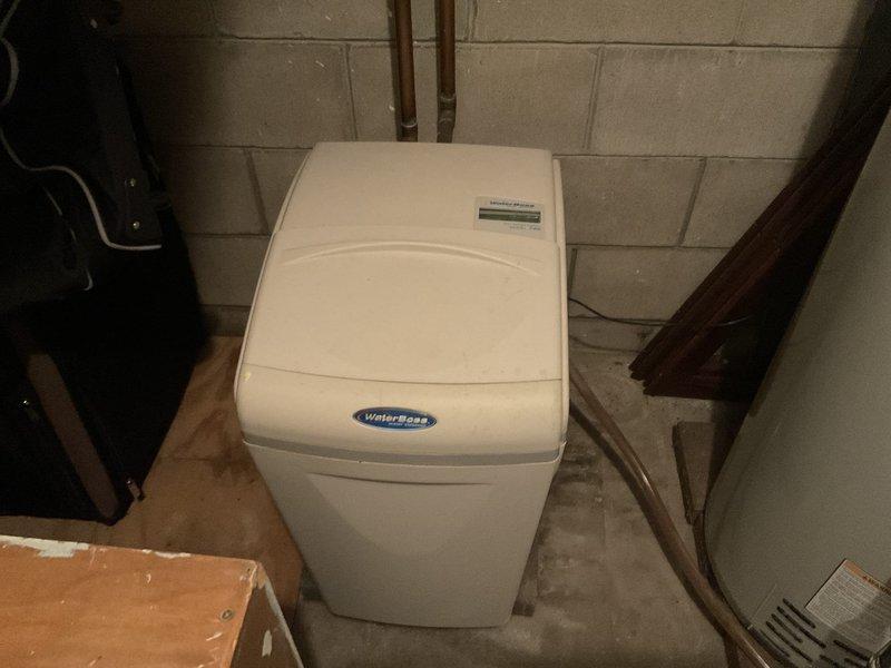 Conducted evaluation of non-functional WaterBoss water softener that was leaking and operating at reduced capacity. Documented existing installation in basement utility area with photos. Provided customer with replacement options including new water softener system and carbon filter.