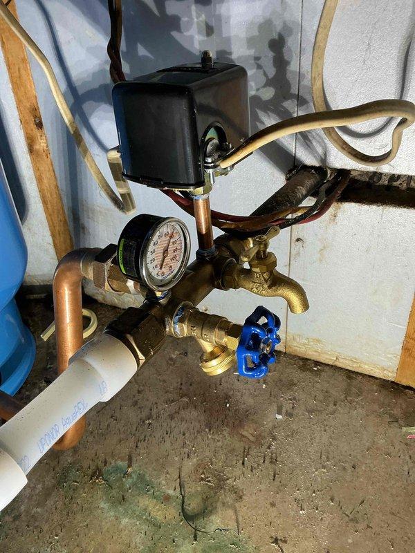 Investigated low water pressure issue affecting multiple areas of residence with no water supply to garage shop. Discovered closed ball valve preventing water flow to the garage shop area. Restored service by opening the ball valve and adjusted pressure switch settings from 60 PSI to 70 PSI to improve overall system pressure throughout the property.