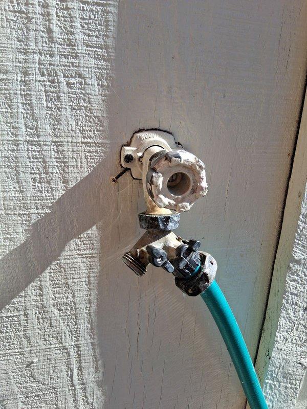 Replaced deteriorated Woodford frost-proof outdoor faucet that was actively leaking and failing to shut off water flow. Installed new frost-proof hose bib to restore proper functionality and eliminate leakage.