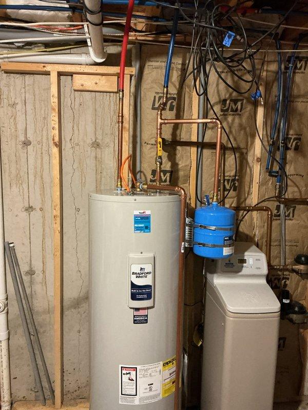 Replaced leaking 50-gallon electric water heater with new unit. Completed installation with existing plumbing configuration, connecting to copper supply lines, PEX tubing, and existing expansion tank. System was successfully installed alongside customer's water softener system in utility area.