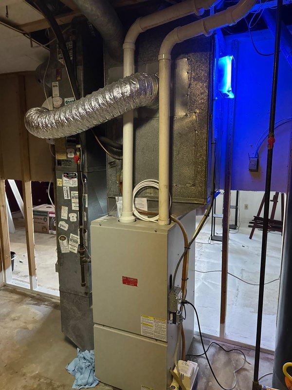 Installed APCO-X Ultra UV Light system to existing HVAC unit in basement mechanical room. Added electrical outlet to furnace switch to provide dedicated power for the UV light installation. Mounted UV light to side of plenum as specified, with successful activation confirmed by visible blue illumination.
