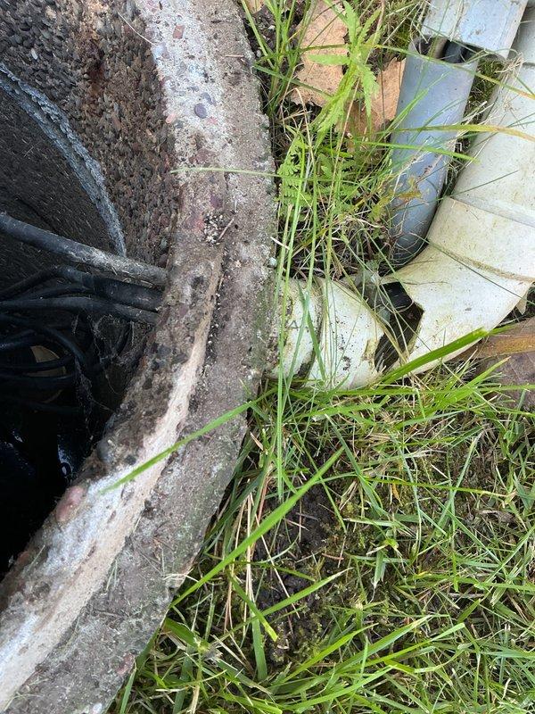 Repaired damaged electrical box for septic system which had been struck by a lawn mower. Removed cracked PVC conduit that housed electrical wiring, then fabricated and installed new PVC components to rebuild the electrical box to proper specifications. System now functioning correctly with protective housing restored.