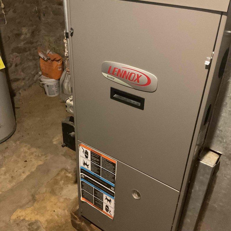 Responded to a No Cool complaint for a Lennox Elite HVAC system. Diagnosed failed blower motor causing medium humming sound with non-functioning fan. Found defective capacitor, replaced both capacitor and motor to restore proper cooling operation.