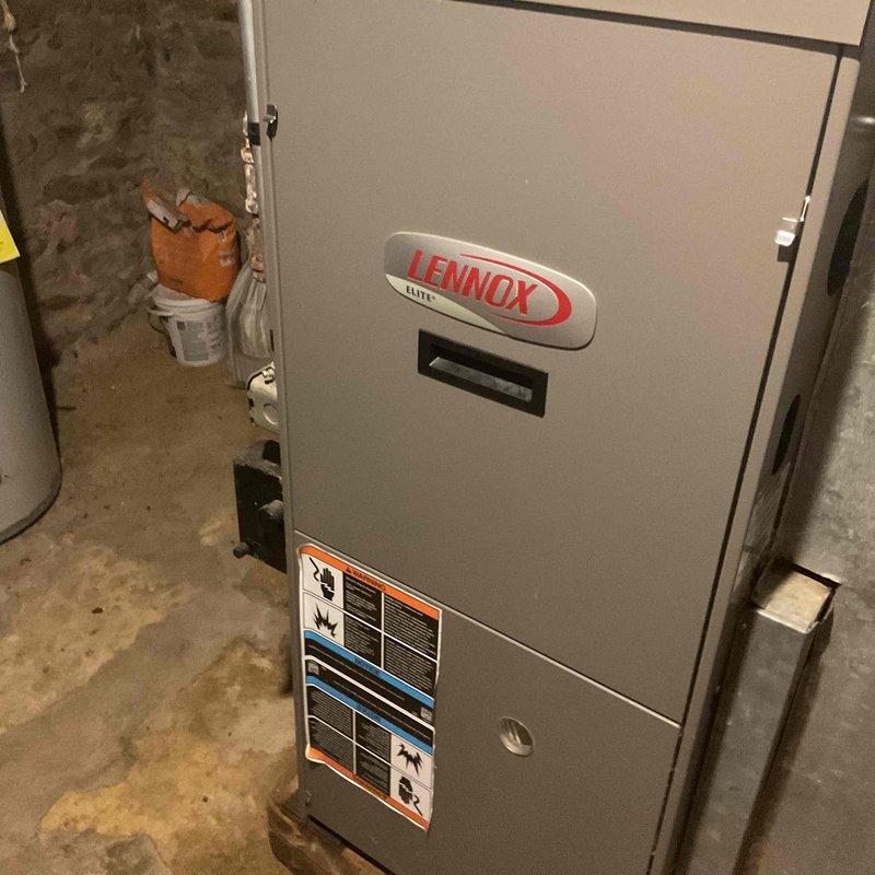 Responded to a No Cool complaint for a Lennox Elite HVAC system. Diagnosed failed blower motor causing medium humming sound with non-functioning fan. Found defective capacitor, replaced both capacitor and motor to restore proper cooling operation.