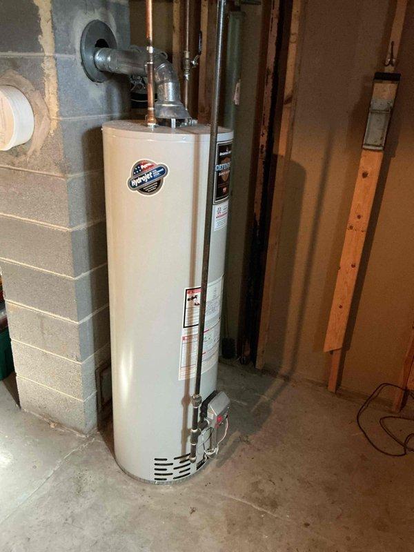 Responded to no hot water service call for Bradford White water heater (2009 model). Diagnosed pilot light extinguishment likely due to recent high winds. Relit pilot successfully and verified proper ignition. Inspected burner assembly and burning chamber, both found to be in excellent condition with no signs of deterioration.