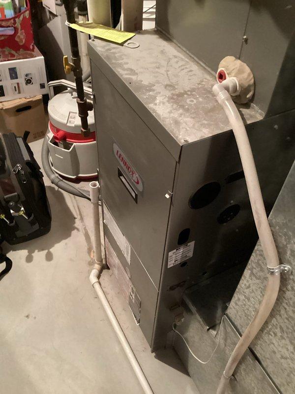 Performed routine tune-up on 18-year-old Lennox furnace. System is operating safely with good igniter and flame sensor condition, though showing signs of age with inducer pulling high amps, oil on blower motor, and some rusting on copper line. Combustion analysis confirmed proper operation with 87.2% efficiency. Recommended humidifier pad replacement.