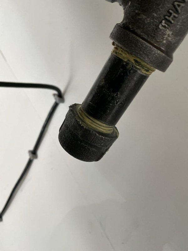 Responded to callback for gas leak investigation. Located source at leaking drip leg cap in garage heater. Applied pipe thread sealant and replaced cap. System tested for leaks with customer verification; currently holding pressure with no leaks detected.