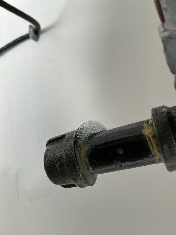 Responded to callback for gas leak investigation. Located source at leaking drip leg cap in garage heater. Applied pipe thread sealant and replaced cap. System tested for leaks with customer verification; currently holding pressure with no leaks detected.