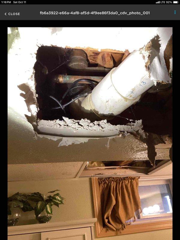 Responded to emergency water leak in basement bathroom ceiling caused by a toilet ring leak in the floor above. Discovered the toilet flange was positioned approximately 1" lower than the surrounding tile, creating a seal failure. Implemented temporary repair by installing two stacked wax rings to create proper seal height and prevent further water damage.
