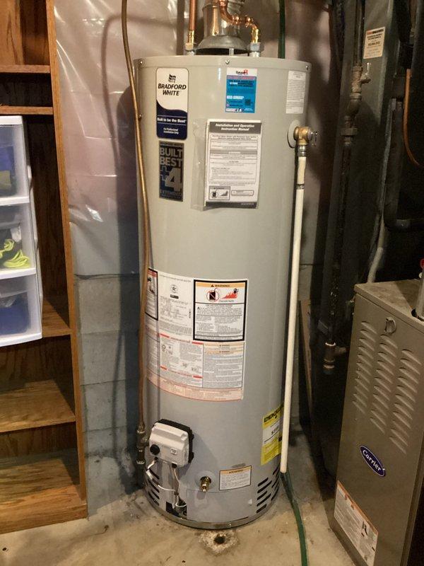 Installed new 40 gallon Bradford White atmospheric water heater in utility room with proper copper piping connections and ventilation system. Completed the installation provided by Hurlburt with all required fittings and ensured proper function of the unit.