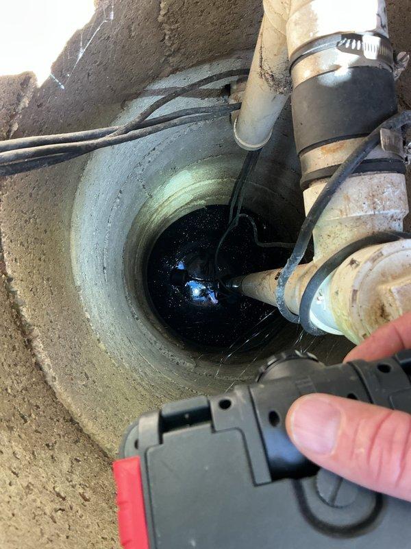 Responded to service call regarding basement backup issue. Upon inspection of customer's septic system, discovered standing water in concrete drainage well with multiple PVC pipe connections. After assessment, determined backup was caused by septic system failure rather than standard clogged drain. Notified customer of findings and explained septic issue requiring specialized service.