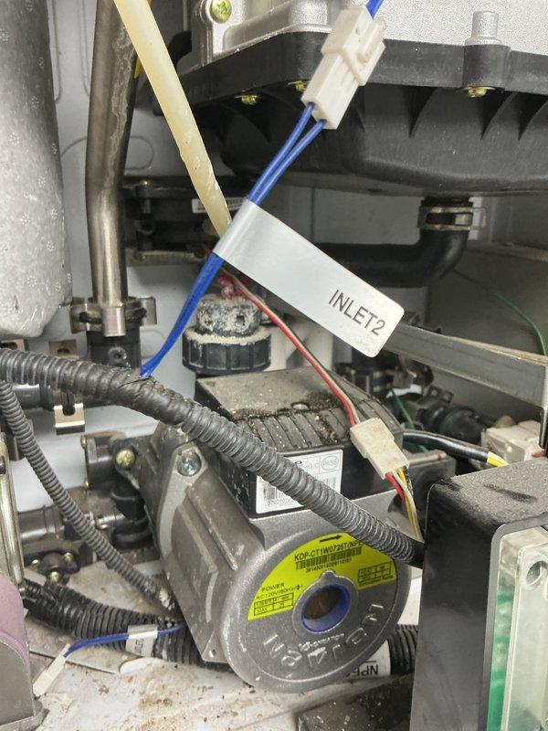 Inspected Navien tankless water heater (model NPE2400) exhibiting error codes and found significant corrosion around the recirculation pump and heat exchanger. Recommended tuneup service to address these issues. Also assessed backing up urinal and recommended augering to clear the blockage.