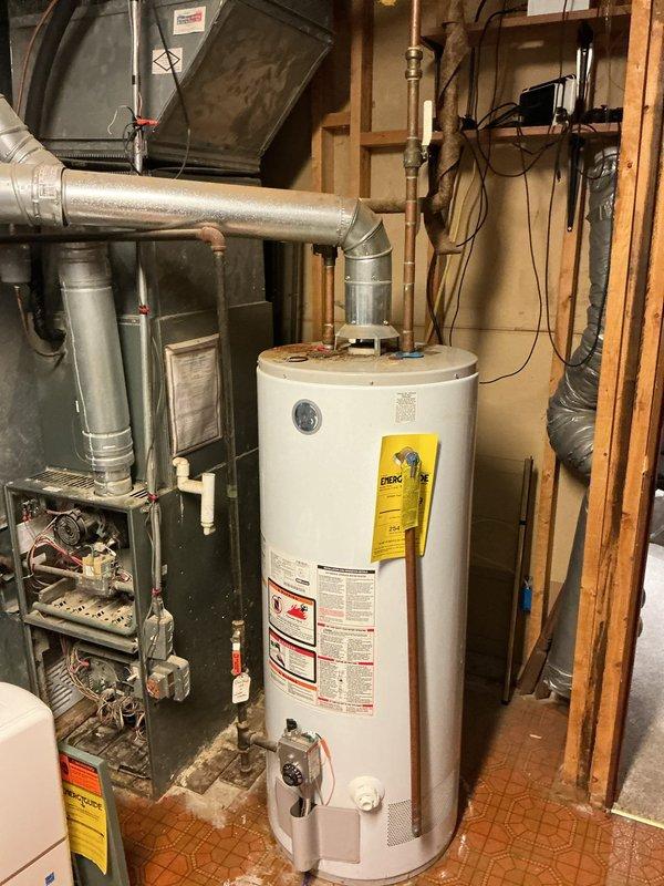 Replaced outdated 40-gallon water heater with new 50-gallon TGL unit due to leaking condition. Addressed possible obstruction in ventilation system and resolved leak issue. Installation completed in utility room with proper connection to existing plumbing and venting systems.
