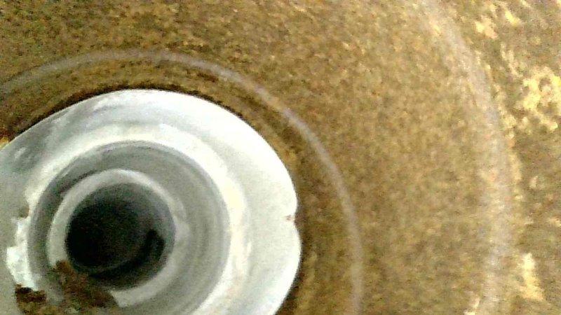 Responded to service call for a leaking furnace. Identified multiple issues including water accumulation in mechanical room and plugged venting system. Cleared obstructed ventilation and documented damaged vent cap that requires replacement on follow-up service visit.