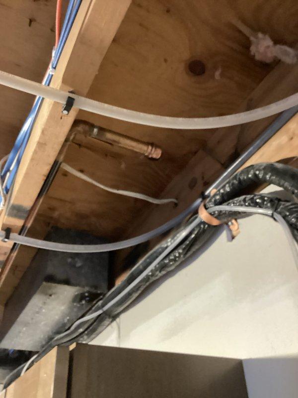 Disconnected hot water baseboard heating system in living room area as requested for remodeling work. Properly capped off supply and return lines after isolation. All other heating zones remain operational while this section undergoes renovation.