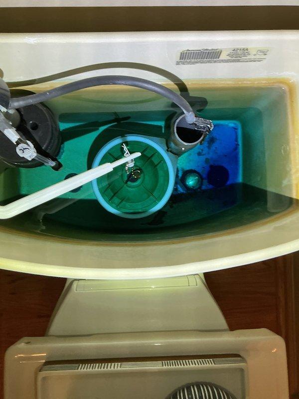 Completed toilet tank rebuild on two fixtures with recurring issues. Removed old internal components and installed new fill valve assemblies, flush valves, and flappers after cleaning mineral deposits from tanks containing blue cleaning solution. All fixtures now operating properly with no leaks.