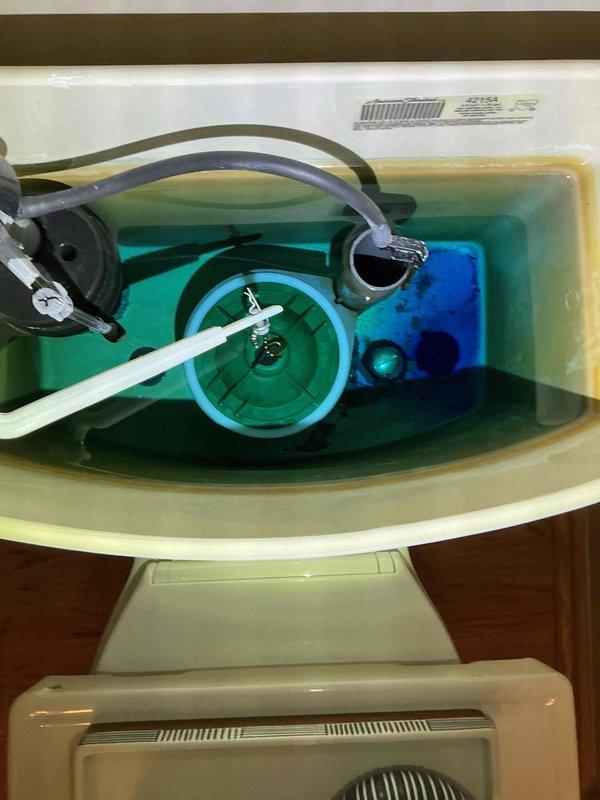 Completed toilet tank rebuild on two fixtures with recurring issues. Removed old internal components and installed new fill valve assemblies, flush valves, and flappers after cleaning mineral deposits from tanks containing blue cleaning solution. All fixtures now operating properly with no leaks.