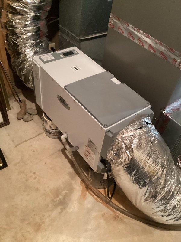 Performed comprehensive annual furnace tune-up including inspection of heat exchanger via camera, verification of all safety components (pressure switch, limit switches, flame sensor, igniter), and combustion air/gas pressure testing. Replaced air filter, reset dehumidifier filter reminder, and adjusted humidifier settings for winter operation. System functioning properly with normal operation verified.