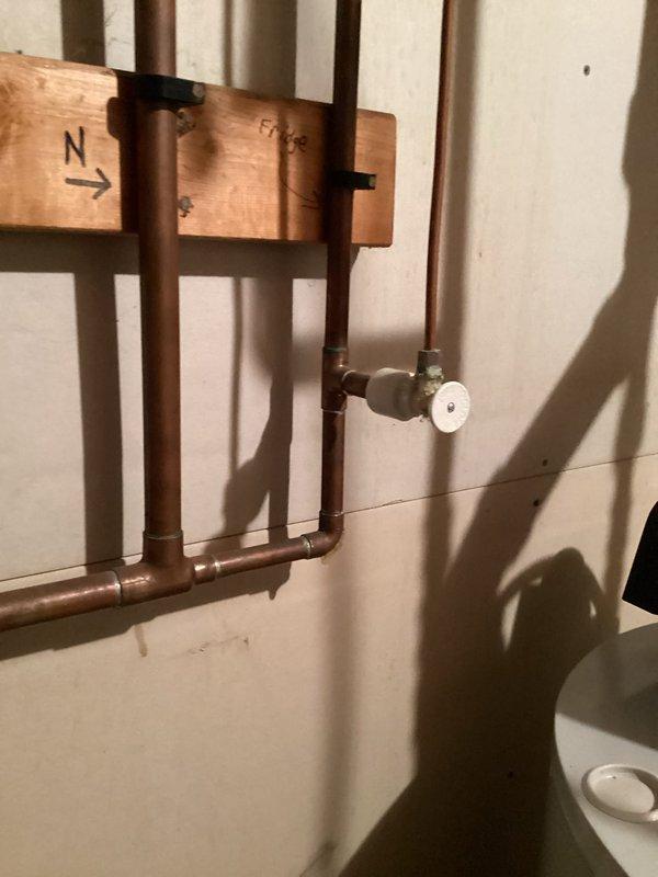 Responded to alarm activation in customer's basement. Upon inspection, determined the alarm was associated with the septic system, not the sump pump. Found drain field saturated causing the septic alarm to trigger. Customer was referred to a septic specialist for further assistance.