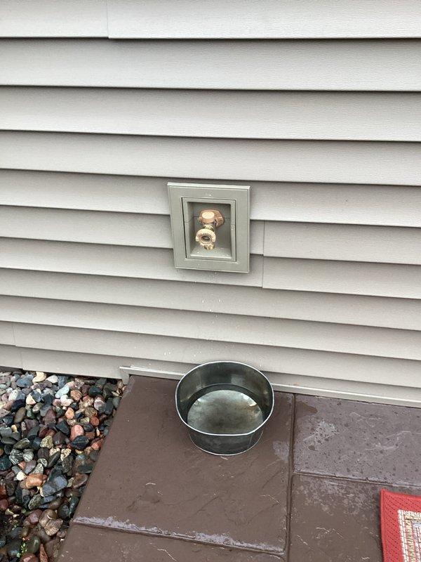 Repaired outdoor water spigot damaged by roofing company by installing a new faucet fixture in the existing recessed access panel. Inspected installation to ensure proper function with no leaks, leaving the completed repair with the new brass hose bibb securely mounted in the exterior wall access box. Repaired outdoor water spigot damaged by roofing company by installing a new faucet fixture in the existing recessed access panel. Inspected installation to ensure proper function with no leaks, leaving the completed repair with the new brass hose bibb securely mounted in the exterior wall access box.