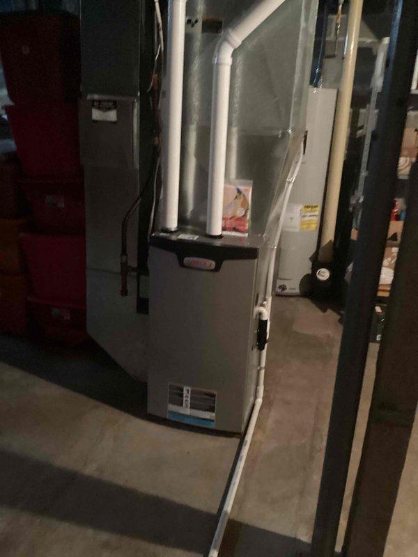 Completed furnace tune-up including cleaning flame sensor, ensuring clear drain line, and inspecting blower and capacitor. System operated properly in both first and second stages with no issues observed. Identified water leak near customer's meter, likely due to recent city pipe replacement; arranged for plumbing department follow-up.