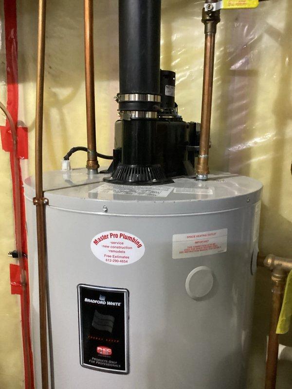 Replaced leaking 20-year-old 48-gallon gas power vent water heater with new Bradford White 50-gallon power vent unit. Identified and replaced non-compliant ABS venting and cellular core piping with proper materials, ensuring code-compliant installation with appropriate exterior venting.