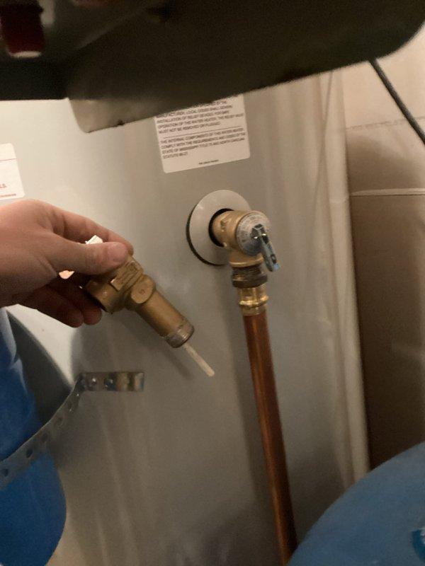 Diagnosed and replaced defective temperature and pressure relief valve on previously installed water heater. Found damaged blue gasket during inspection which had caused the valve to leak. Removed compromised components and installed new TMP valve to restore proper system pressure and safety functionality.