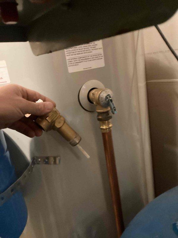 Diagnosed and replaced defective temperature and pressure relief valve on previously installed water heater. Found damaged blue gasket during inspection which had caused the valve to leak. Removed compromised components and installed new TMP valve to restore proper system pressure and safety functionality.