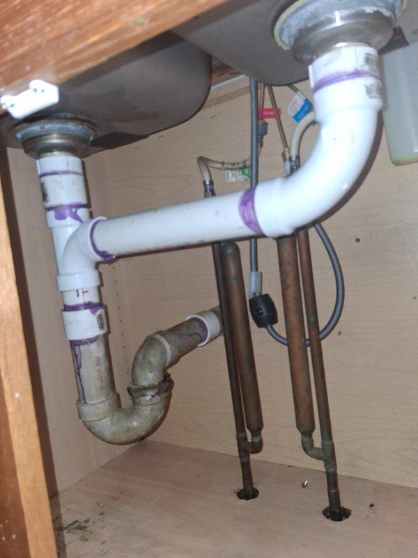 Successfully replaced customer-supplied kitchen faucet along with installing new shut-off valves to replace the 30+ year old ones. Rebuilt drain system with new PVC piping, properly connecting all components with primer at joints and installing P-trap configuration to ensure proper drainage and eliminate the previous pieced-together appearance. Successfully replaced customer-supplied kitchen faucet along with installing new shut-off valves to replace the 30+ year old ones. Rebuilt drain system with new PVC piping, properly connecting all components with primer at joints and installing P-trap configuration to ensure proper drainage and eliminate the previous pieced-together appearance.