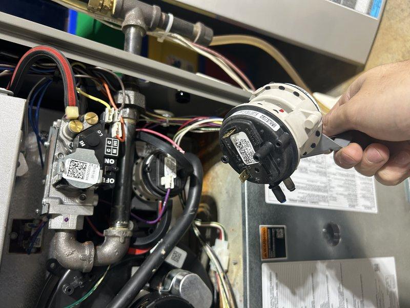 Responded to no-heat warranty call where diagnostics revealed failed pressure switches. Replaced pressure switch pack, cleaned and later replaced flame sensor, and ultimately replaced control board to resolve persistent low flame current error code. System was tested in all operational modes with good flame rectification confirmed.