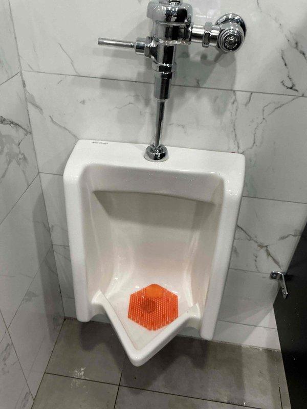 Responded to service call for a clogged urinal. Disassembled the urinal fixture, performed drain snaking procedure to clear the blockage, then reassembled the unit. Verified proper drainage function before completing the service.