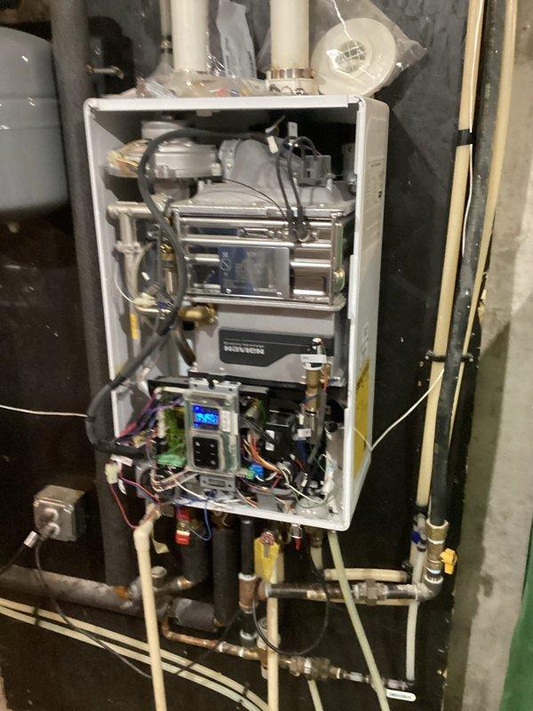 Diagnosed Navien tankless water heater (approximately 7-8 years old) exhibiting no hot water condition with error code E001. After inspection of internal components, determined main pump and motherboard failure. Presented customer with options for complete unit replacement with new Navion model or component repair service. Diagnosed Navien tankless water heater (approximately 7-8 years old) exhibiting no hot water condition with error code E001. After inspection of internal components, determined main pump and motherboard failure. Presented customer with options for complete unit replacement with new Navion model or component repair service.