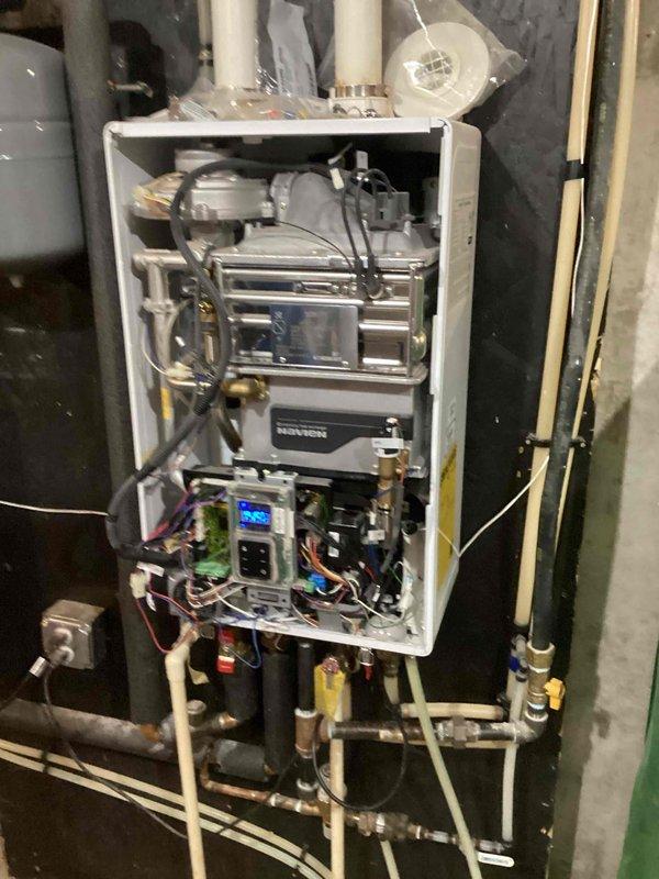 Diagnosed Navien tankless water heater (approximately 7-8 years old) exhibiting no hot water condition with error code E001. After inspection of internal components, determined main pump and motherboard failure. Presented customer with options for complete unit replacement with new Navion model or component repair service. Diagnosed Navien tankless water heater (approximately 7-8 years old) exhibiting no hot water condition with error code E001. After inspection of internal components, determined main pump and motherboard failure. Presented customer with options for complete unit replacement with new Navion model or component repair service.