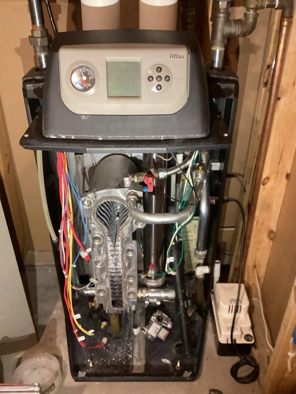 Responded to no heat call for Weil-McLain Ultra LP boiler system installed in 2010. Diagnostic testing revealed flame detection failure. Removed and cleaned flame sensor, accessed heat exchanger for thorough cleaning, and performed system flush to restore proper operation. Post-service verification confirmed boiler now functioning correctly with normal flame detection.