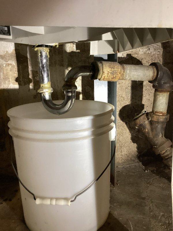 Repaired leak issues in laundry tub and drain system by replacing compromised P-trap assembly and boiler drain. Visual inspection revealed significant corrosion at connection points with active leaking that required immediate attention. Installation of new components restored proper drainage function and eliminated all leak points.