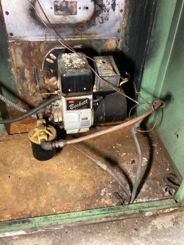 Responded to a no-heat call for an aging oil furnace. Upon inspection, found system non-operational. Performed comprehensive diagnostic check including oil line, burner assembly, ignition system, relays, and burner tube. Bled the oil line to remove air and cycled the unit to restore proper ignition. Verified functionality of fan relay, temperature settings, blower, belt, zone board, and dampers. System successfully returned to normal heating operation with proper ignition and combustion restored.