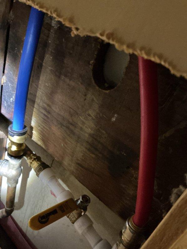Resolved clogged bathroom sink drain by augering the lavatory line to restore proper drainage. Repaired water leak by replacing damaged section of piping behind shower, which included installing new hot water valve to prevent further water intrusion into wall cavity. All plumbing systems now functioning correctly with no visible leaks.
