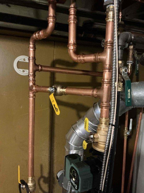 Addressed radiator heating issue on recently installed boiler system by adjusting bypass valve and increasing pump speed to restore proper heat flow to sunroom radiator. Performed complete boiler inspection which revealed no additional issues except a leaking ball valve from previous system. Discussed remediation options for the valve leak with customer.