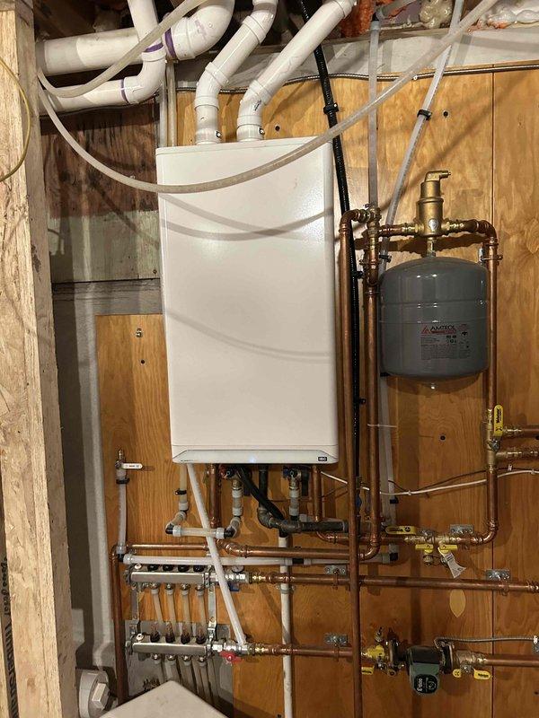 Performed warranty service to replace failed control board on heating system. Installed new control board sourced via PO #189684-002 and verified proper operation of all zone heating and domestic hot water functions after replacement.
