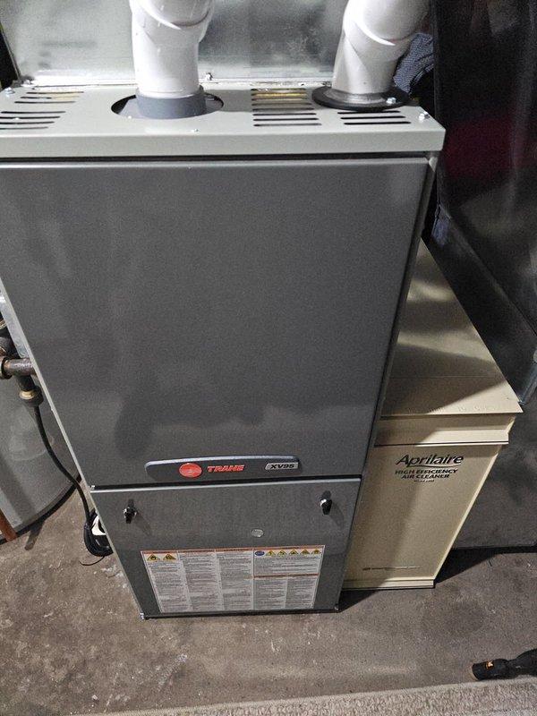 Performed annual furnace tune-up on Trane XV80 system. Inspected and found clean filter and blower, verified all electrical components within specifications. During heat exchanger inspection, discovered concerning rings and a crack on the burner inlet. Showed damage to customer, explained safety concerns, and recommended repair options. Tagged furnace as non-operational pending service advisor follow-up.
