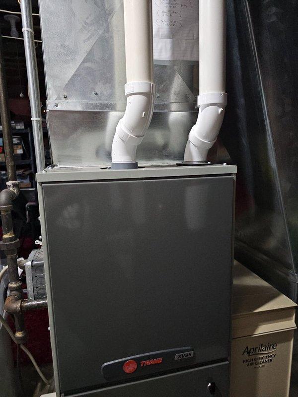 Performed annual furnace tune-up on Trane XV80 system. Inspected and found clean filter and blower, verified all electrical components within specifications. During heat exchanger inspection, discovered concerning rings and a crack on the burner inlet. Showed damage to customer, explained safety concerns, and recommended repair options. Tagged furnace as non-operational pending service advisor follow-up.