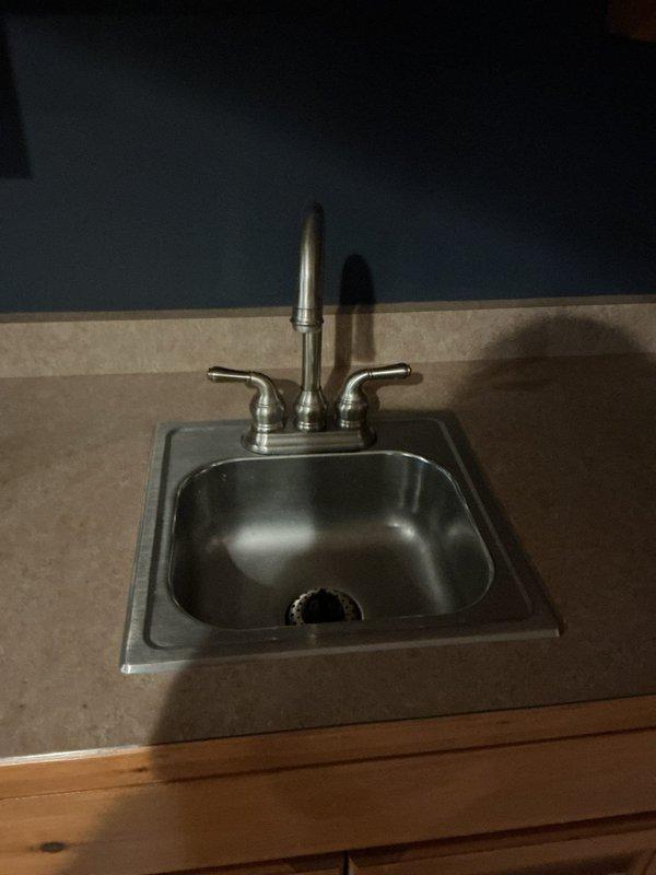 Performed annual maintenance on natural gas water heater and resolved restricted water flow issue at kitchen sink. Discovered blockage in hot water supply line causing reduced flow; cleared obstruction by blowing out the line. Completed system flush of water heater, noting absence of calcium and magnesium deposits.