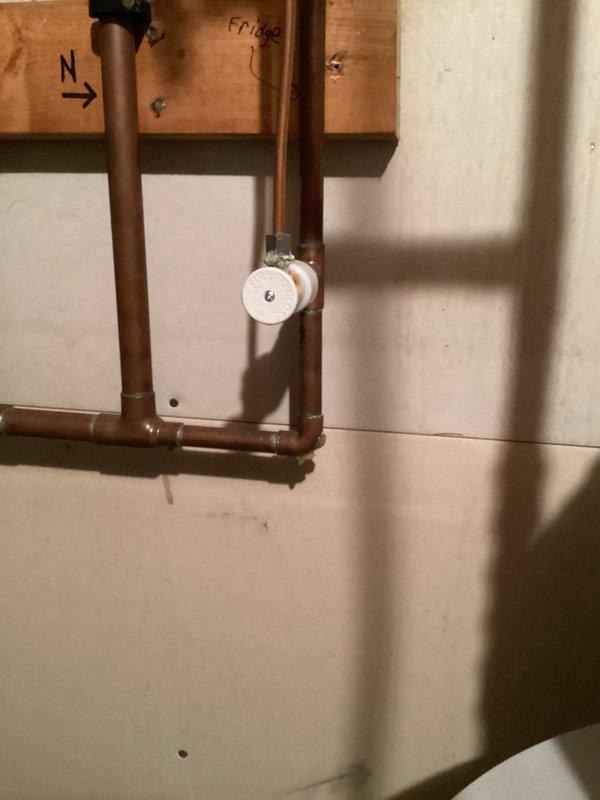 Responded to emergency call for a leaking fridge valve and supply line in customer's utility room. Diagnosed the issue in the copper plumbing configuration connecting to the refrigerator. Replaced the damaged fridge valve and supply line, restoring proper water flow and eliminating leakage.