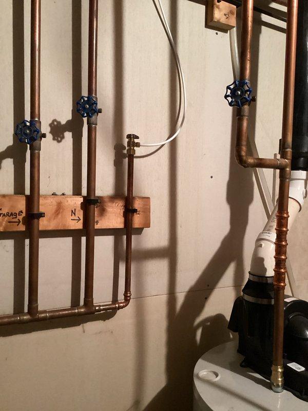 Responded to emergency call for a leaking fridge valve and supply line in customer's utility room. Diagnosed the issue in the copper plumbing configuration connecting to the refrigerator. Replaced the damaged fridge valve and supply line, restoring proper water flow and eliminating leakage.