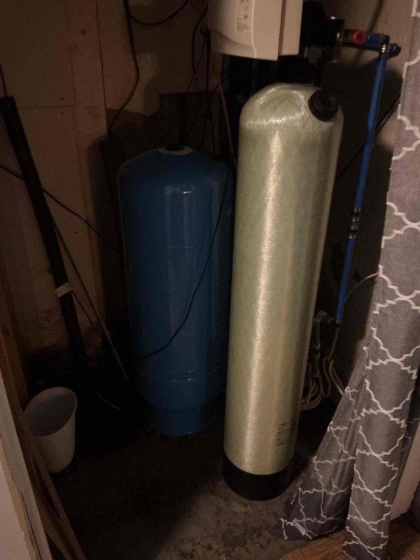 Responded to emergency call for copper pipe burst in basement with customer unable to completely shut off water source. Determined pressure tank had ruptured and electrical panel lacked proper labeling for well pressure pump. Located correct fuse and panel, shut off water to the well, and replaced damaged pressure tank with equivalent model to restore proper system functionality.