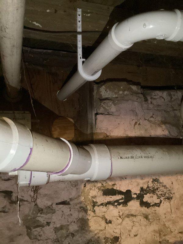 Successfully installed customer-supplied LP water heater with proper pressure-temperature relief valve. Ensured all PVC vent pipes were correctly positioned and secured to the exterior wall, and verified drainage system connections to the main waste line were properly supported with metal hangers against the foundation wall.