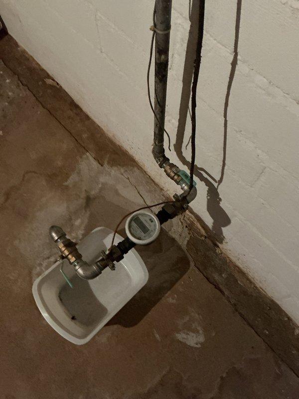 Responded to a service call for a water leak in customer's basement mechanical room near the main water supply. Upon inspection, discovered defective valves installed during previous water service replacement by the village, which were causing persistent leakage. Customer was advised of repair options, and documentation was provided for potential involvement of the village utility department since the issue stems from their original installation work.