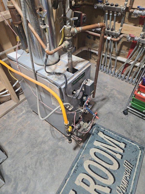 Diagnosed 5-year-old HydroTherm boiler with no heat issue. Investigation revealed disconnected thermostat wire that wasn't properly secured in terminal. Repaired connection by properly inserting wire into terminal, restored signal path from thermostat to control system. Tested full system operation after repair, confirming proper ignition sequence and normal heating function.