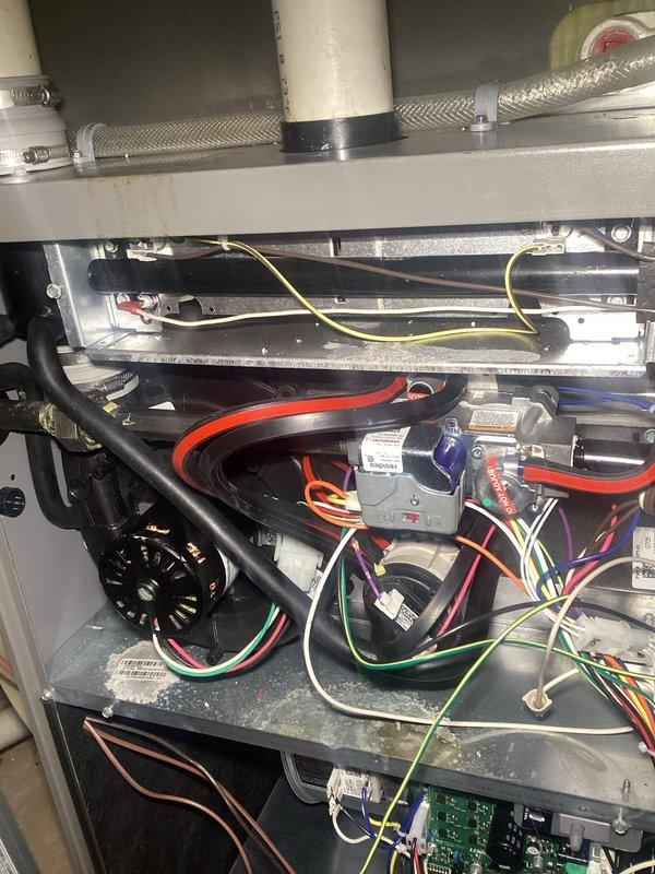 Performed comprehensive furnace tune-up on residential unit. Inspected filter (noted as getting dirty), verified clean and balanced blower, and checked all electrical components finding them within specifications. Identified water damage in upper and lower cabinets from condensate backflow through intake. Unit operation tested at maximum heating rate for 15 minutes with 70°F temperature rise (within 60-90°F specification range). Recommended installation of in-line drain to prevent further condensate damage; customer requested estimate.